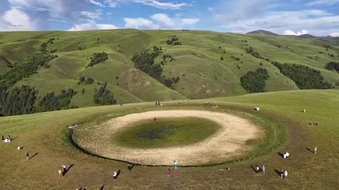 Aerial View of Mysterious Circular Earthwork on Rolling Green Steppe Stock Footage 328120799
