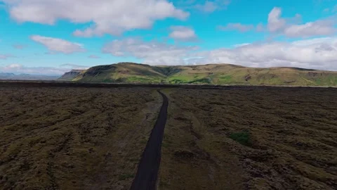 Aerial View Of Narrow Road Through Mossy Lava Fields In Iceland 動画素材 342708786