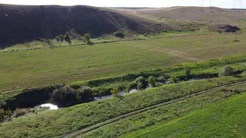 Aerial view of a narrow stream among fields near Mariupol, Donetsk region. Stock Footage 312902490