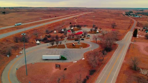 Aerial View of Native American-Themed Rest Area with Teepee Structures Along Stock Footage 303011136