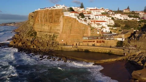 Aerial view of a natural pool in the ocean and a seaside village Video stock 221581268