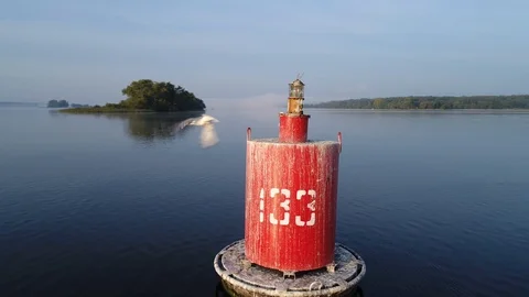 Aerial view. Navigate mark on river at sunrise. Seagull takes off from buoy. Stock Footage 97801962