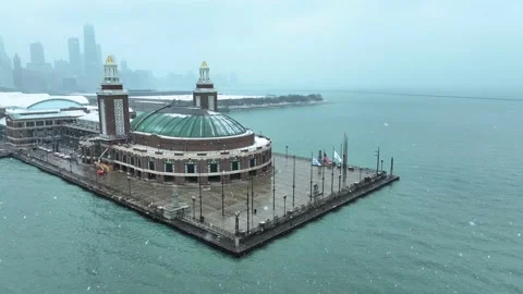 Aerial view of Navy Pier with view of Chicago skyline in background on snowy day Stock Footage 231163317