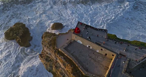 Aerial view of Nazare Lighthouse.The worlds biggest waves crashing against the 库存影片 311802553