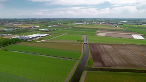 Aerial view of network of lush green fields and canal s in Netherlands coun.. Stock Footage 246727564