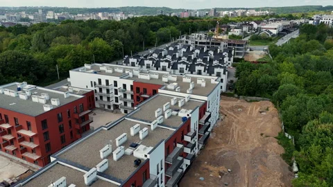 Aerial view of a new apartment complex beside an active construction area Stockbeeldmateriaal 346606458