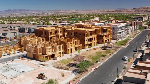 Aerial view of new condominium construction in Las Vegas suburbs with mountains Stock Footage 200859370