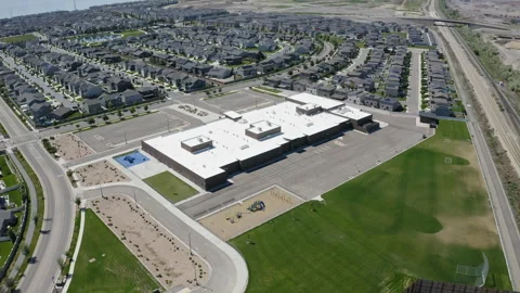 Aerial view of new elementary school building by neighborhood, Vineyard Utah Stock Footage 247989012