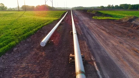 Aerial view of new pipeline being constructed, in light of sunrise Stock Footage