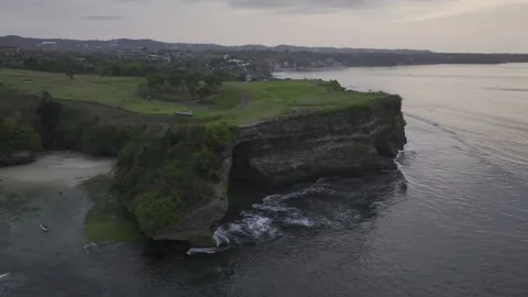 Aerial view of nightfall landscape of coast cliff of Jimbaran in Bali Indonesia Stock Footage 266896241