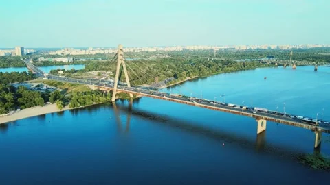 Aerial view of the North Bridge over the Dnipro River and road traffic at Sunset Stock Footage 200974422