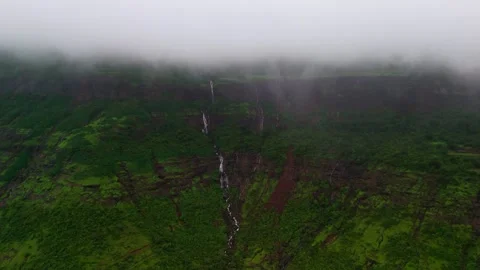 Aerial View of Numerous Small Waterfalls Cascading Through Lush Green Mountains Vídeos de archivo 342701631