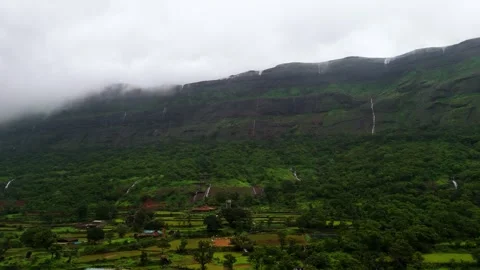 Aerial View of Numerous Small Waterfalls Cascading Through the Mountains Видео 342701780