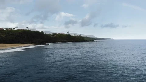 Aerial view of the ocean, camera moves away from a tropical island Stock Footage 145139603