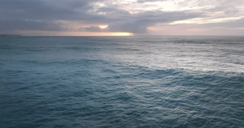 Aerial view of ocean during sunset. Drone flying over a sea surface in the Stock Footage 223425486
