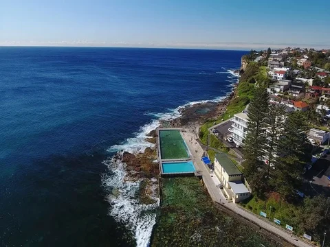 Aerial view Ocean Rock Pool Horizon line Hotel building Stock Footage 70770143