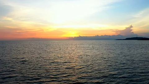 Aerial view of the ocean surface during sunset. Drone flying above the sea Stock Footage 128044848