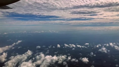 Aerial View of Ocean Surface with Scattered Cumulus Clouds at Sunrise Stock Footage 310323470