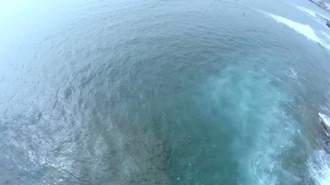Aerial view of the ocean. Surfers on the surface of the water waiting for a wave Stock Footage 107879760