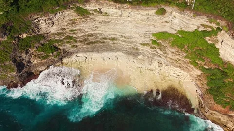 Aerial View of Ocean Turquoise Waves Breaking on Hidden Beach in Bali Stock Footage 340658798