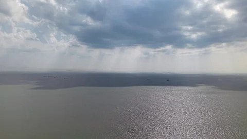 Aerial view of ocean under dramatic, cloudy skies Stock-Footage 337543719