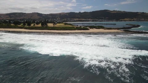 Aerial view of ocean wave and coastal town harbour Vídeos de archivo 336004778