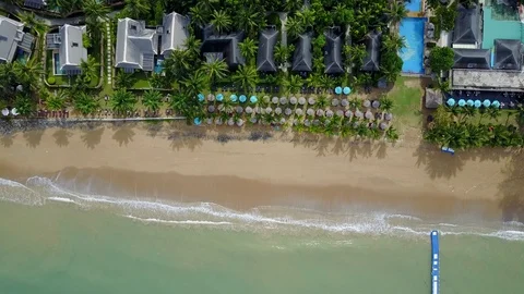 Aerial view of ocean wave reaching the beach near resort Stock Footage 91090532