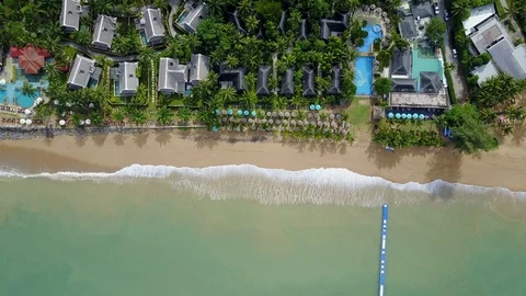Aerial view of ocean wave reaching the beach near resort Stock Footage 91091265