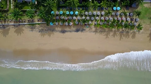 Aerial view of ocean wave reaching the beach near resort Stock Footage 91093837
