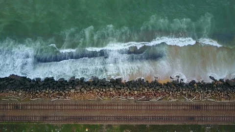 Aerial view of ocean wave reaching coast rocks with railway along the coastline Stock-Footage 124400900