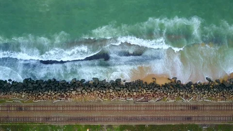 Aerial view of ocean wave reaching coast rocks with railway along the coastline Stock-Footage 124401358