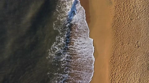 Aerial View Of Ocean Wave Reaching The Sandy Coastline. Summer Beach Stock Footage 239574486
