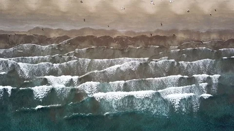 Aerial view of ocean waves and people walking on the beach Video stock 105681650