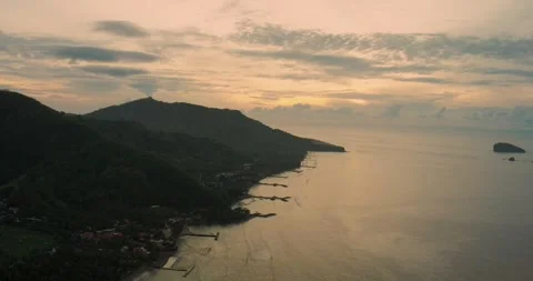 Aerial View of Ocean Waves and Tropical Shoreline During Golden Sunset Stock Footage 331188529