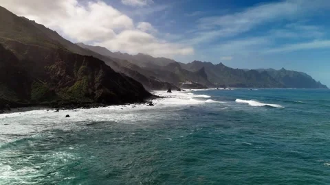 Aerial view of ocean waves and rugged cliffs, Roque de las Bodegas, Tenerife Stock Footage 336453277