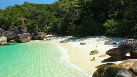 Aerial view of ocean waves, beach and rocky coastline and beautiful forest Stock Footage 125321776