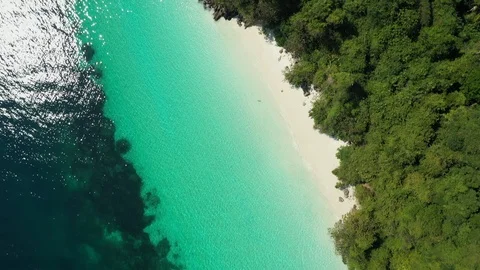 Aerial view of ocean waves, beach and rocky coastline and beautiful forest 動画素材 125682858