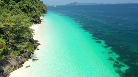 Aerial view of ocean waves, beach and rocky coastline and beautiful forest Stock Footage 126099951