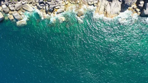 Aerial view of ocean waves, beach and rocky coastline and beautiful forest Stock Footage 127429963