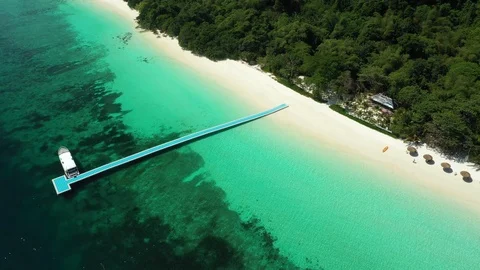 Aerial view of ocean waves, beach and rocky coastline and beautiful forest Stock Footage 127430632