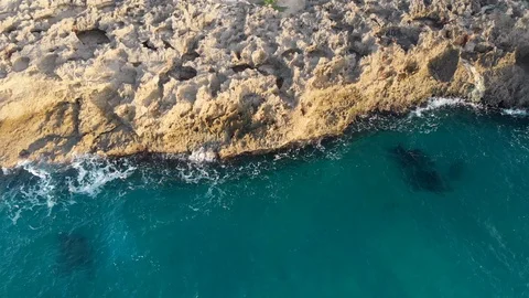 Aerial view as ocean waves break on the rif Stock Footage 101486922