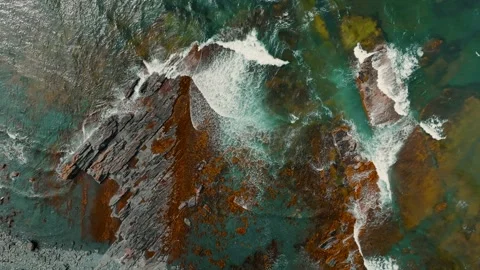 Aerial view of ocean waves breaking on rocky beach Stock Footage 270528438