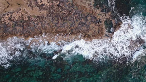 Aerial view of ocean waves breaking on a rocky shore. Abstract nature background Stock Footage 273472787