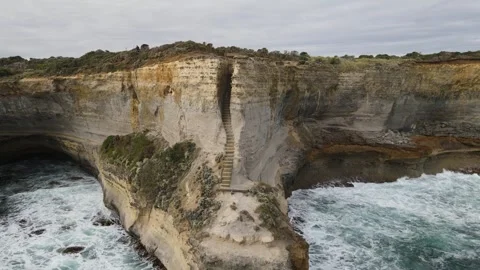 Aerial View of Ocean Waves Breaking on Australia Cliffs Stock Footage 335981043