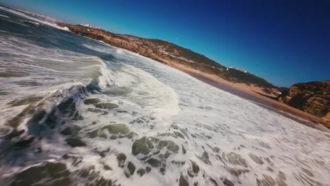 Aerial view of ocean waves breaking along rocky coastline Stock Footage 339786142