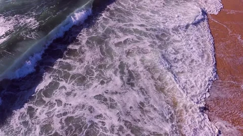 Aerial View of Ocean Waves Breaking on Sandy Shore Stock Footage 340837163