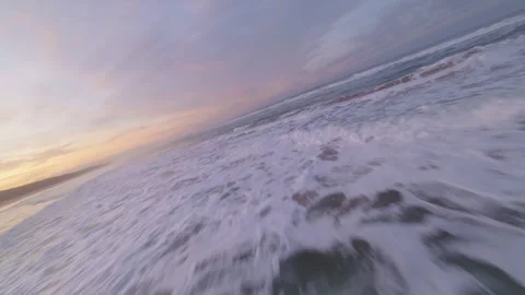 Aerial view of ocean waves breaking on beach during dawn Stock Footage 344542738