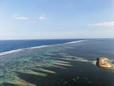 Aerial View of Ocean Waves Breaking Over Coral Reefs and Blue Sea Horizon Stock Photos