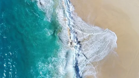 Aerial view of ocean waves crashing on beach by 4K drone footage. Stock Footage