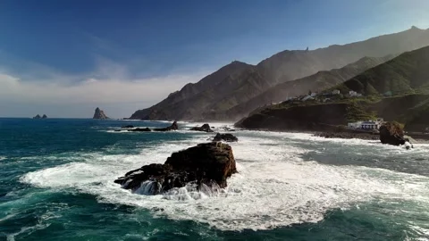 Aerial view of ocean waves crashing on rocks, Roque de las Bodegas, Tenerife Stock Footage 336446781